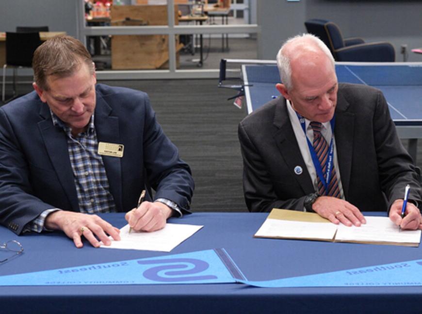 Dr. Paul Illich, SCC president, and Bill Motzer, vice president for enrollment management at NWU, sign the Biotechnology Pathway Agreement.